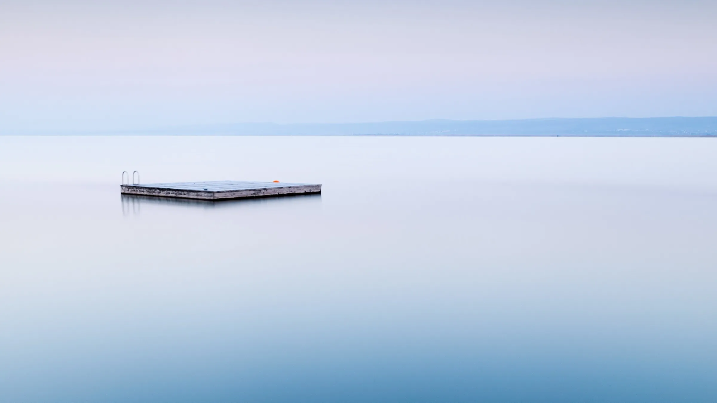 A concrete square floating in a calm sea